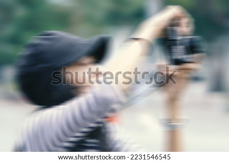 Blurred image of woman photographer shoot photo in outdoor