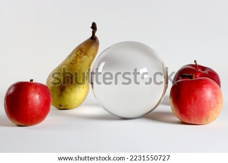 three bright red pear apples and a glass layer on a white background