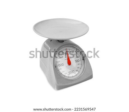 A analog food scale isolated on a white background.