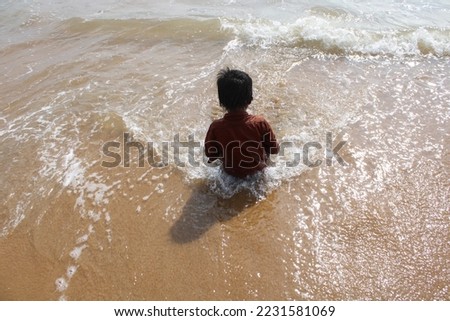 Little boy playing in the beach