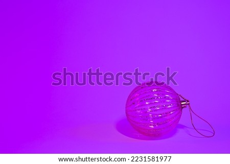 Christmas tree ball in neon light isolated, copy space.