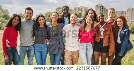 Large group of multiethnic friends posing hugging outdoors smiling and looking at camera - diversity, friendship, oneness, union and people lifestyle concept Royalty-Free Stock Photo #2231587677