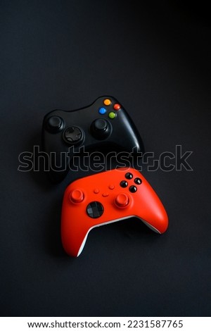 Two gamepads on a black background. Game concept, esports, leisure, gaming industry, video games. Flat lay, top view