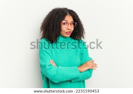 Young african american woman isolated on white background suspicious, uncertain, examining you. Royalty-Free Stock Photo #2231590453