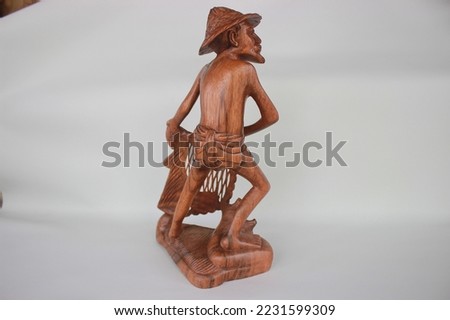 	
Balinese Wooden Fisherman Sculpture Wood Carving, Sculpture, Art from Bali Indonesia Royalty-Free Stock Photo #2231599309