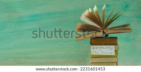 Stack of hardback books with knowledge is the future sign.Learning,education,knowledge,back to school concept.