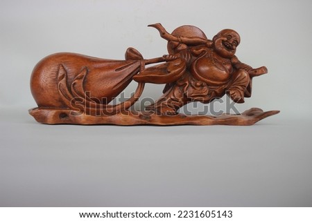 	
Balinese Wooden Laughing Buddha Statue Carving, Sculpture, Art from Bali Indonesia Royalty-Free Stock Photo #2231605143
