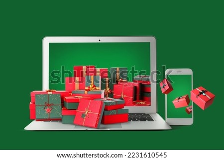 Laptop and mobile phone with gifts on green background