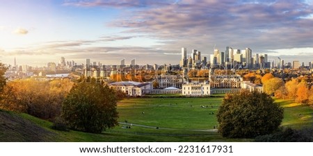 Panoramic view of the London skyline from Canary Wharf to the City seen from Greenwich Park during golden autumn sunset time Royalty-Free Stock Photo #2231617931