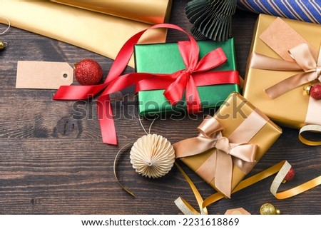 Festive christmas new year background colorful and gold gift boxes and holiday decorations on wooden background. New Year's present and Christmas present top view