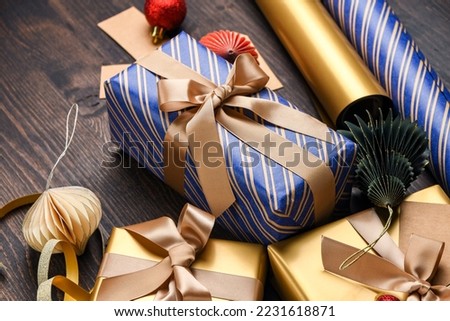 Festive christmas new year background colorful and gold gift boxes and holiday decorations on wooden background. New Year's present and Christmas present top view