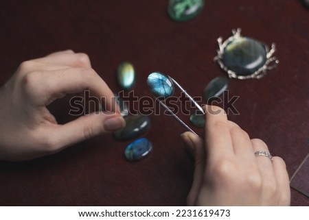 Close up labradorite concept photo. Woman at work. Side view photography with professional instrument on background. High quality picture for wallpaper, travel blog, magazine, article