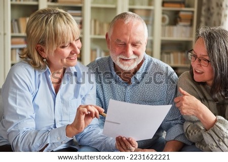 Senior couple and a tax consultant are talking about a contract or application for old-age provision Royalty-Free Stock Photo #2231622221