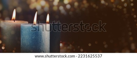 Three burning candles in the Advent season - Christmas decoration for the senses - Xmas background banner, panorama with copy space	