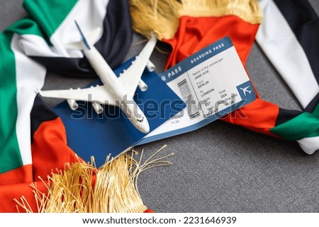 UAE flag with passport, ticket and toy plane