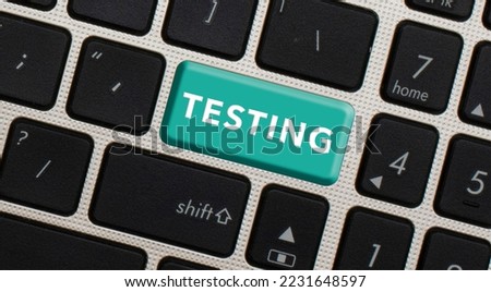 Concept of Quality Testing. Testing word written on black keyboard