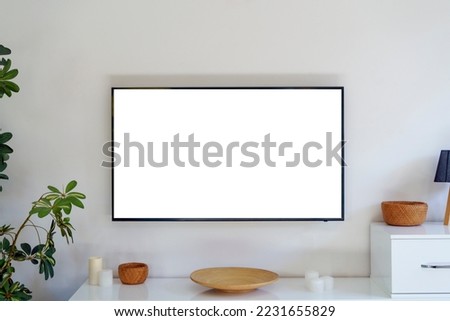 TV led mock up screen. Smart TV on a wall in an empty white interior living room. Royalty-Free Stock Photo #2231655829