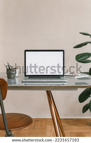 Office workplace. Blank laptop screen mockup on the table. Modern workplace. Minimal style. Copy space.