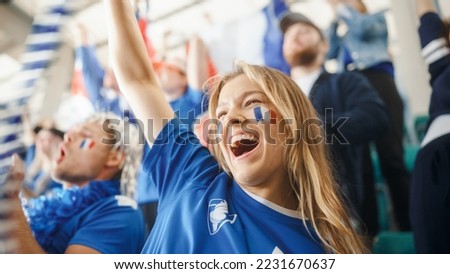 Sport Stadium Big Event: Portrait of Beautiful Sports Fan Girl with French Flag Painted Face Cheering For Her Team to Win. Crowd of Fans Shout, Celebrate Scoring a Goal, Championship Victory Royalty-Free Stock Photo #2231670637