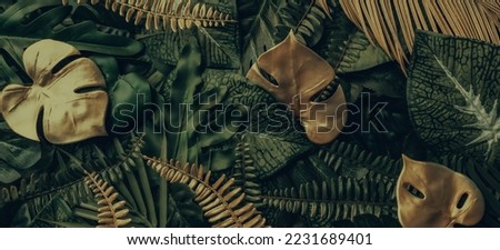 Creative nature background. Gold and green tropical Monstera and palm leaves. Minimal summer abstract jungle or forest pattern. Royalty-Free Stock Photo #2231689401