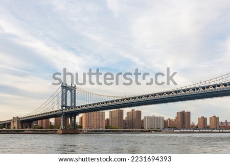 Sunset afterglow of the Manhattan Bridge and New York City skyline at New York