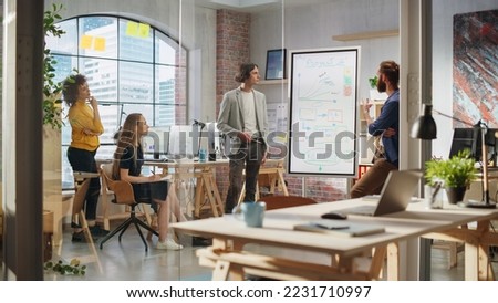 Junior Marketing Specialist Making a Team Presentation in Creative Office Meeting Room. Project Manager Showing a Fresh Product Timeline. Project Plan Presentation on Digital Whiteboard Monitor Royalty-Free Stock Photo #2231710997