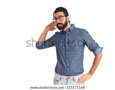 Young hipster man listening over white background  Royalty-Free Stock Photo #223171168