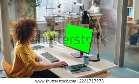 Confident Arab Businesswoman Working on Implementing Modern Business Strategy in Creative Agency. Specialist Writing Corporate Project Plan on Desktop Computer with Green Screen Mock Up Display.