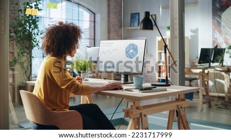 Portrait of a Happy Middle Eastern Manager Working in Creative Office. Business-Driven Stylish Female with Curly Hair Using Desktop Computer with a Calendar Software on Screen Display. Royalty-Free Stock Photo #2231717999