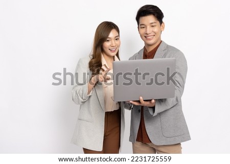 Asian businessman and businesswoman looking at laptop computer isolated on white background