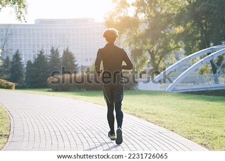 Man running in park at autumn morning. Healthy lifestyle concept	  


                             
