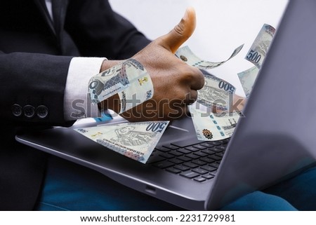 Saudi riyal notes coming out of laptop with Business man giving thumbs up, Financial concept. Make money on the Internet, working with a laptop