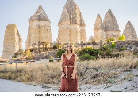 Woman tourist on background of Unique geological formations in Love Valley in Cappadocia, popular travel destination in Turkey Royalty-Free Stock Photo #2231732671