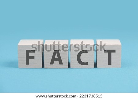 Fact is standing on wooden cubes, truth concept, social media and news