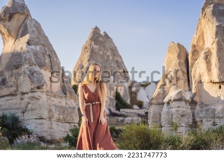 Woman tourist on background of Unique geological formations in Love Valley in Cappadocia, popular travel destination in Turkey Royalty-Free Stock Photo #2231747773