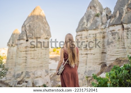 Woman tourist on background of Unique geological formations in Love Valley in Cappadocia, popular travel destination in Turkey Royalty-Free Stock Photo #2231752041
