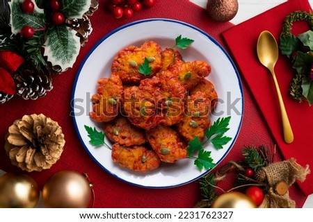 Pumpkin and apple fritters on a table with Christmas decorations. Christmas Dessert.