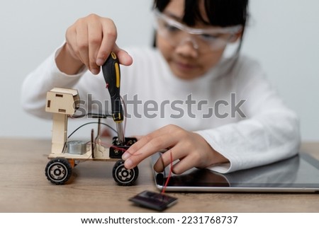 Asia students learn at home in coding robot cars and electronic board cables in STEM, STEAM, mathematics engineering science technology computer code in robotics for kids concept. Royalty-Free Stock Photo #2231768737