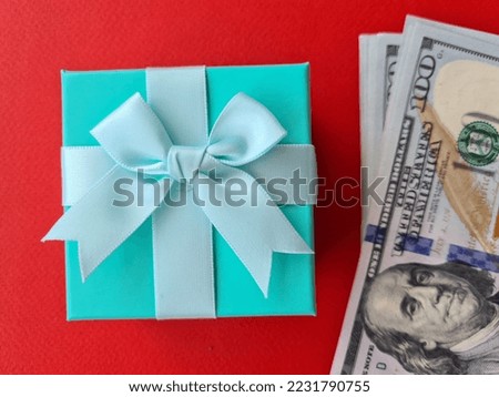 Dollar banknotes and surprise gift box. Gift choice and financial budget