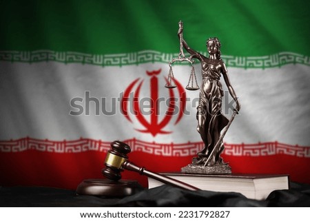 Iran flag with statue of lady justice, constitution and judge hammer on black drapery. Concept of judgement and punishment Royalty-Free Stock Photo #2231792827