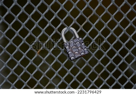 lovers' locks with inscriptions hang on the wire fence. it is locked and the key is thrown into the water