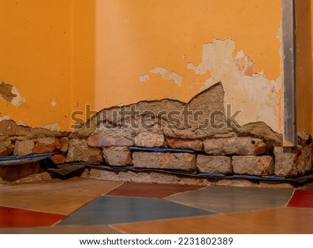 Undercut wall in an old house for moisture removal Royalty-Free Stock Photo #2231802389