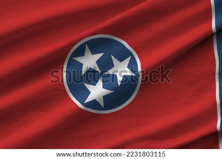 Tennessee US state flag with big folds waving close up under the studio light indoors. The official symbols and colors in fabric banner Royalty-Free Stock Photo #2231803115