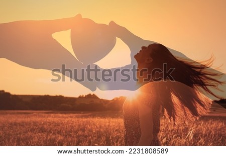Love sets you free. Young woman in the sunlight with feelings of hope, giving and receiving love and compassion.  Royalty-Free Stock Photo #2231808589