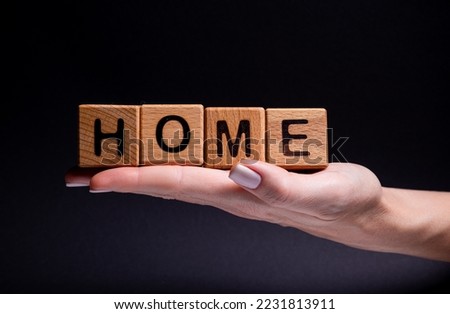 Female hands holds a cube with letters, wooden cubes with words rent sale , buy and loan. Project for designer on black background . Words home learn , health