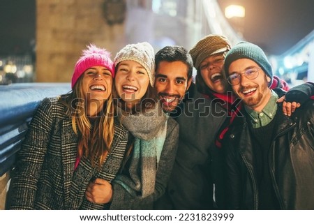 Young friends having fun outdoor during winter time - Soft focus on center faces