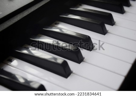An image of a piano keyboard. Selective focus image.