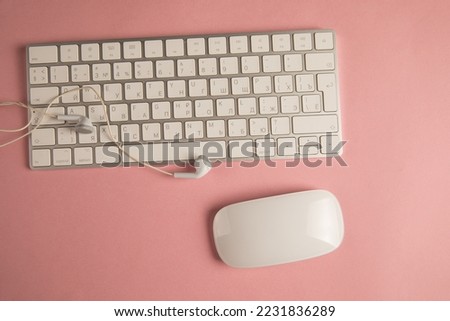 Keyboard and wired headphones on desktop