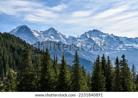 View on the mountain range Eiger Moench and Jungfrau in the Swiss alps on a sunny day Royalty-Free Stock Photo #2231840891