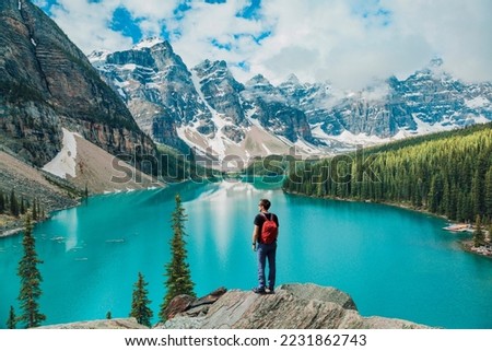 Canada travel man hiker at Moraine Lake Banff National Park, Alberta. Canadian rockies landscape people hiking with backpack lifestyle Royalty-Free Stock Photo #2231862743